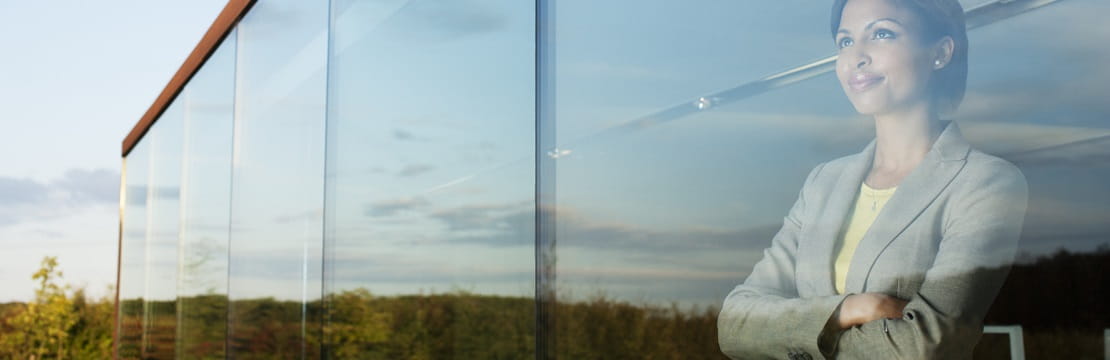 Businesswoman looking out office window.